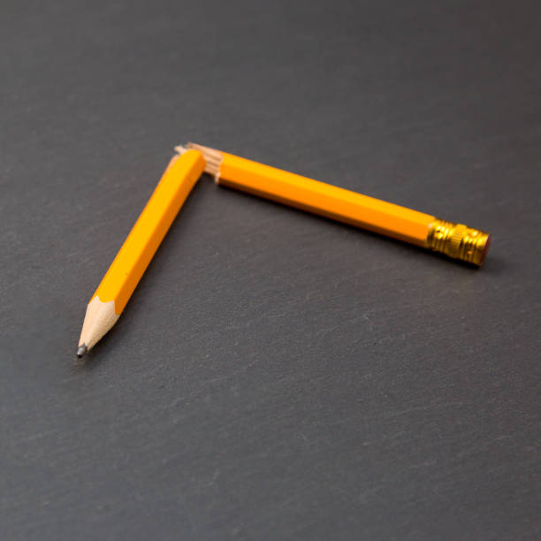 istock Broken into two parts yellow pencil on a gray background 1322873643
