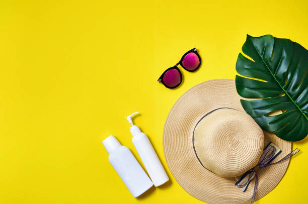 istock Straw hat, pink sunglasses and palm leaf on yellow background. Creative minimal concept 1322873700