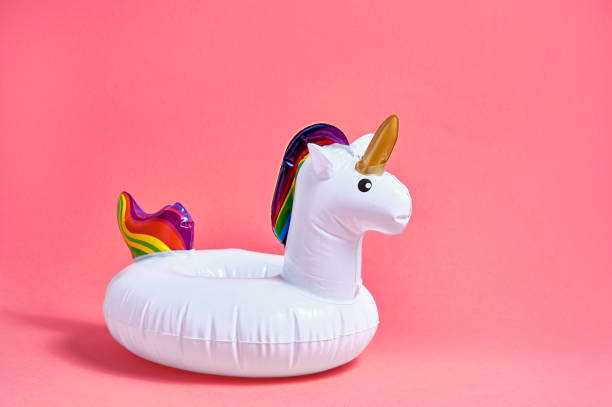 istock Inflatable white unicorn pool toy on pink background. Creative minimal concept 1322873728
