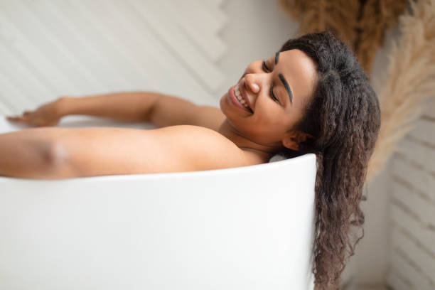 istock Black Woman Taking Bath Relaxing Lying In Bathtub In Bathroom 1322876112