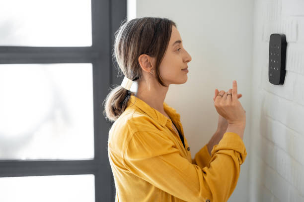 istock Woman enters a code on the alarm keyboard at home 1322876251