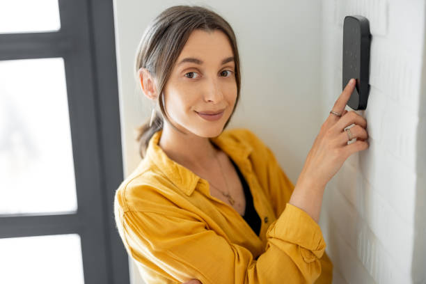 istock Woman enters a code on the alarm keyboard at home 1322876278