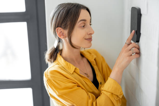 istock Woman enters a code on the alarm keyboard at home 1322876297