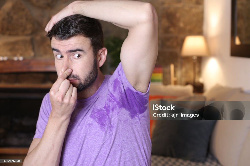 Concerned man with wet and smelly armpit Concerned man with wet and smelly armpit. 35-39 Years Stock Photo