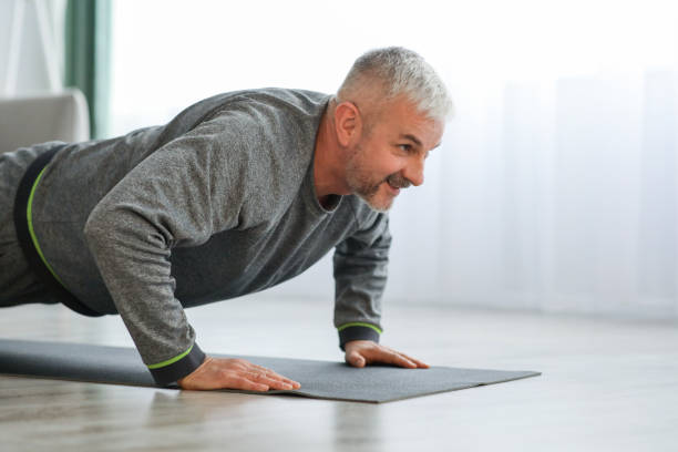 istock Closeup of elder man exercising at home 1322877670