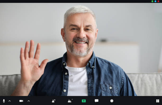 istock Handsome senior man having video conference, waving at camera 1322877687