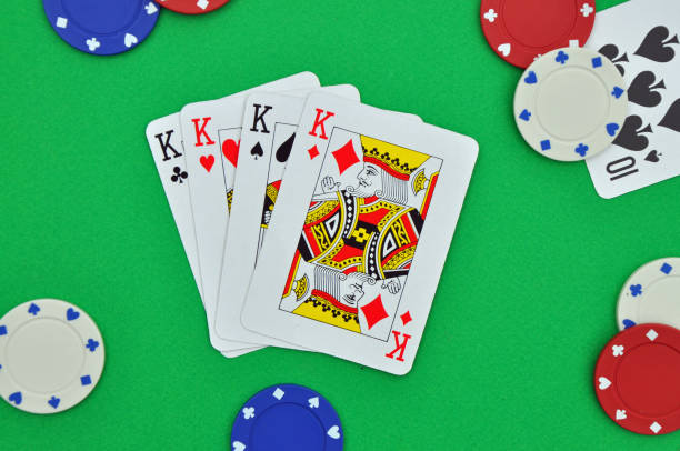 Four of a kind. Poker hand of playing cards. Gambling or gaming Four of a kind (four of the same kind of card i.e. kings). Poker hand or suit. Generic playing cards with poker chips on green baize. Gambling gaming or betting. Exciting and risky leisure activity. hand of cards stock pictures, royalty-free photos & images