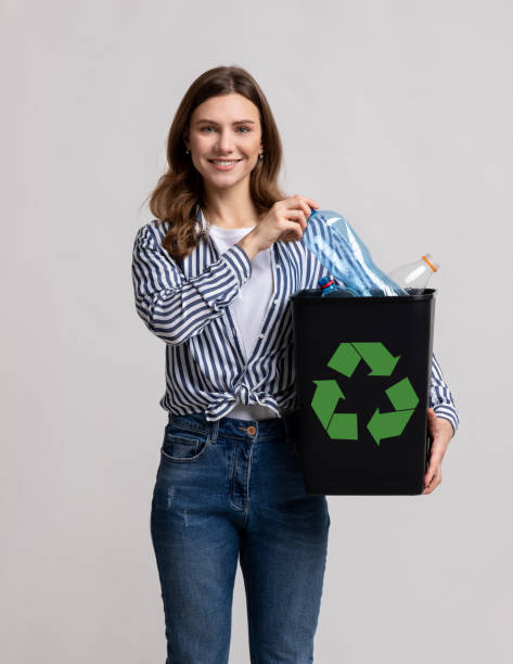 istock Plastic Reuse. Positive Millennial Lady Carrying Black Container Filled With Empty Bottles 1322879421