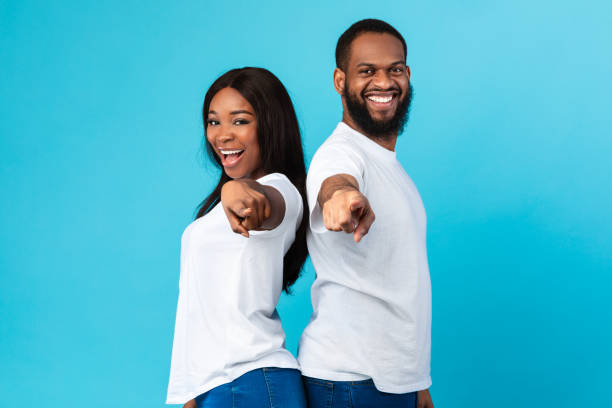 istock Smiling black couple pointing at camera, choosing you 1322879630