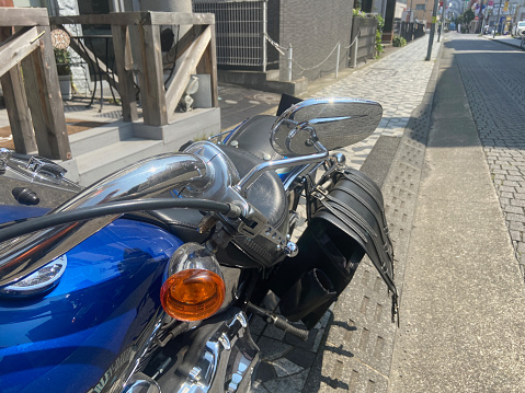 Looking at the shopping street through the steering wheel of a classic American-style large motorcycle, shooting record June 10, 2021 Kumegawa shopping street, Higashimurayama city, Tokyo, Japan.
