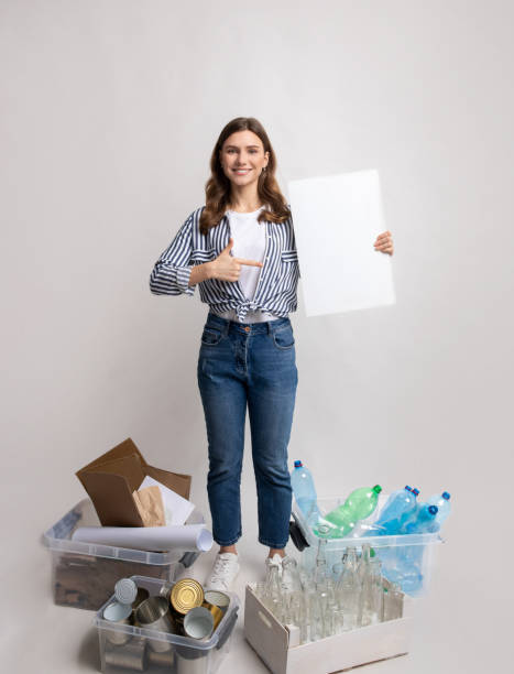 istock Eco-Volunteer Woman With Blank Placard Standing Among Containers With Different Sorted Waste 1322879981