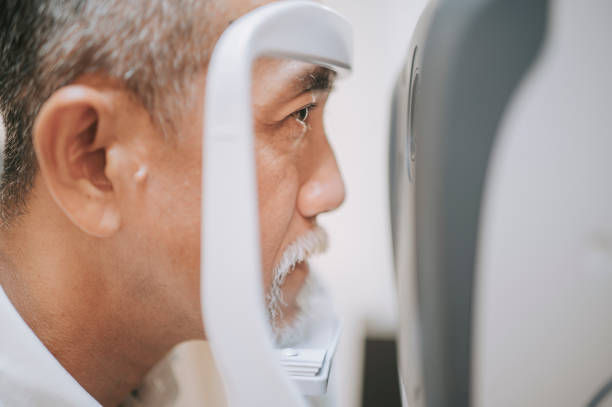 side view asian chinese senior aan having an eye exam at ophthalmologist's office side view asian chinese senior aan having an eye exam at ophthalmologist's office glaucoma photos stock pictures, royalty-free photos & images