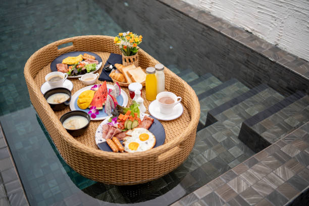 istock Floating breakfast Asian girl Eat breakfast by the pool. 1322881007