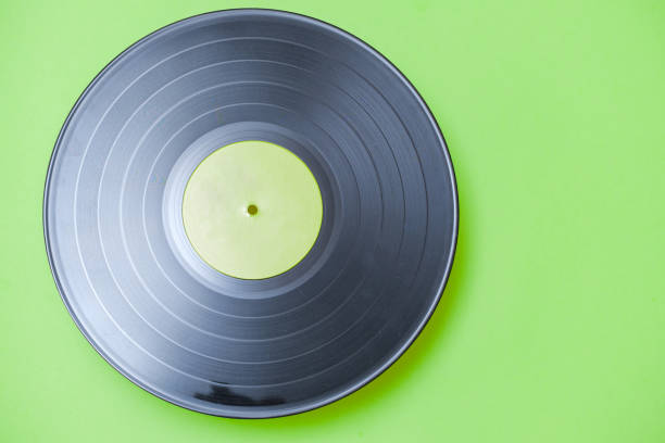 istock old vinyl record lies on green background 1322882478