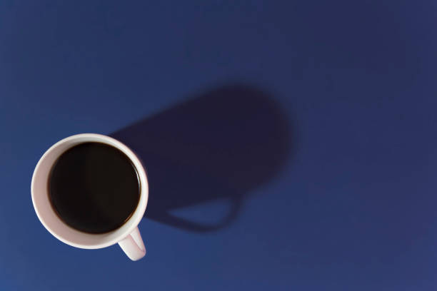 istock cup of coffee on a blue background top view 1322885759