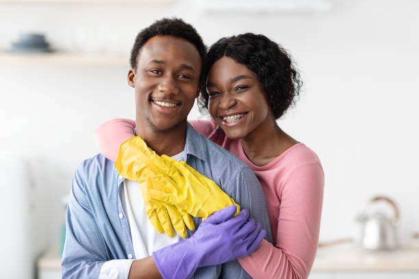 istock Happy black lovers embracing while cleaning house 1322886017