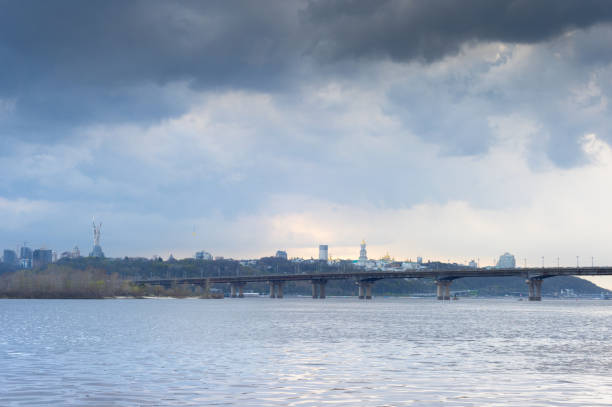 Dnipro river Paton skyline Kiev View of Mother Motherland monument above Dnipro river with Paton bridge and Kiev city in a rainy day, Ukraine dnipropetrovsk stock pictures, royalty-free photos & images
