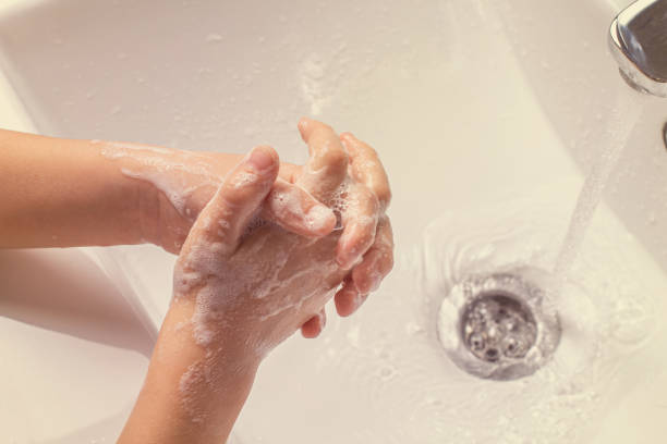 istock washing children's soapy hands under running water in the sink. 1322888299