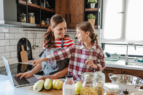 istock Mother and daughter in the kitchen 1322888365