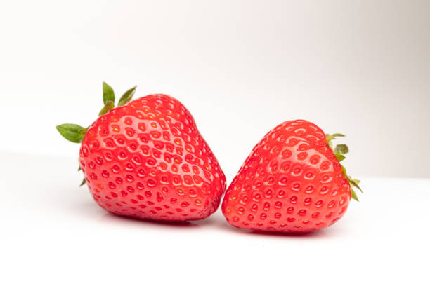Free Stock Photo of Two Berries and a Strawberry on a White Background ...