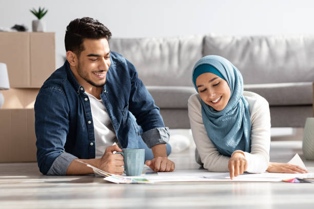 istock Excited muslim family with apartment plan drinking tea 1322890015