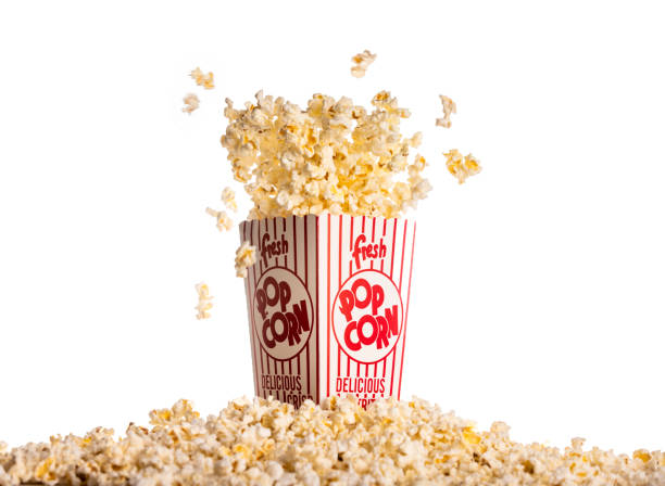 Movie Theater Popcorn High quality stock photos of a box of movie theater popcorn bursting from the box. popcorn stock pictures, royalty-free photos & images