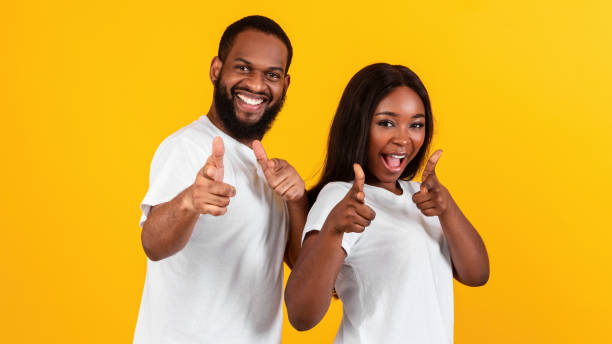 istock Smiling black couple pointing at camera, choosing you 1322891203