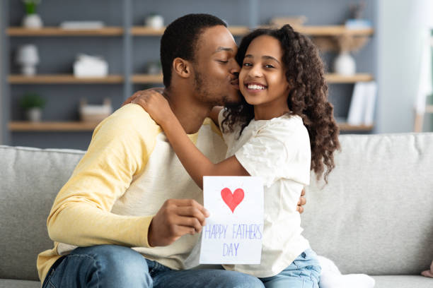 istock Adorable black daughter greeting her dad with Fathers Day 1322891234