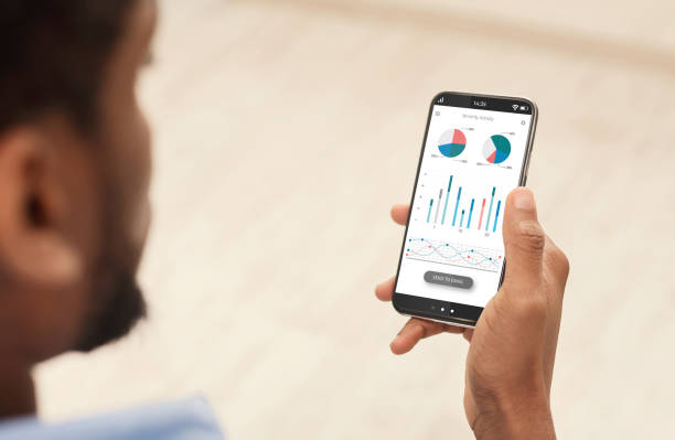 istock Cropped of black man using analytics mobile app on smartphone 1322892053