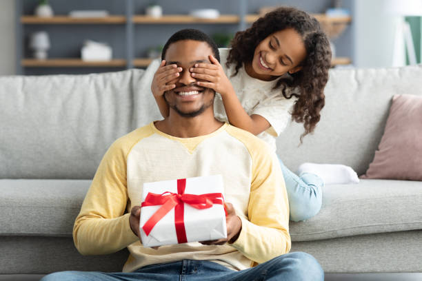 istock Playful curly daughter making surprise for her father 1322892608
