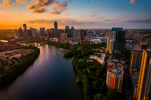 Austin Texas USA Aerial Drone view over lady bird lake at Golden Hour sunset with amazing view of Skyline Cityscape of downtown urban capital city at sunset with amazing clouds and color