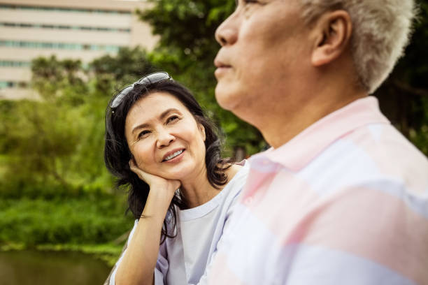 istock Senior couple relaxing in the park 1322893775