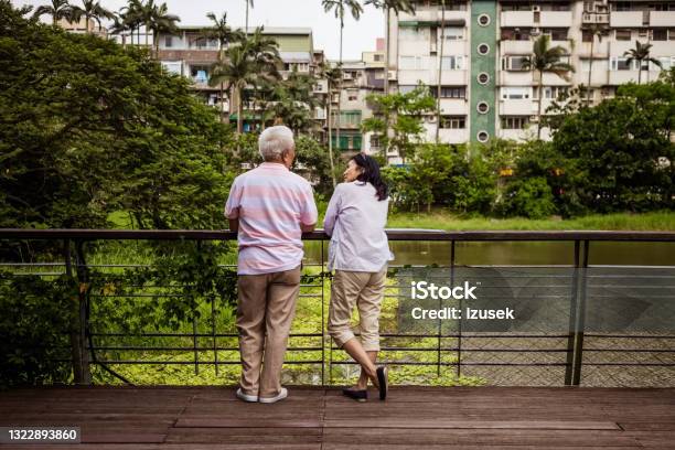 Senior Couple Relaxing In The Park Stock Photo - Download Image Now - Friendship, Asia, People