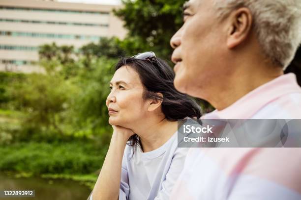 Senior Couple Relaxing In The Park Stock Photo - Download Image Now - Asia, Asian and Indian Ethnicities, Introspection