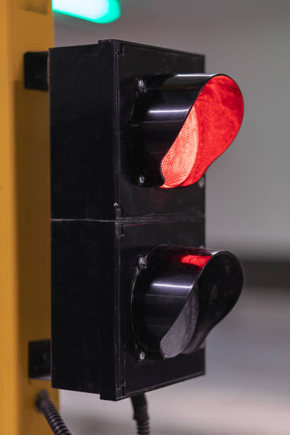 istock Vertical shot traffic lights closeup turn red when entering or exiting parking lot. 1322894777