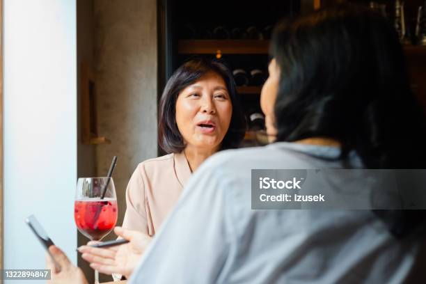 Senior Friends Enjoying Drink In Cafe Stock Photo - Download Image Now - 60-69 Years, 70-79 Years, Adult