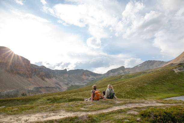 istock Hiking couple relax in mountain meadow 1322896878