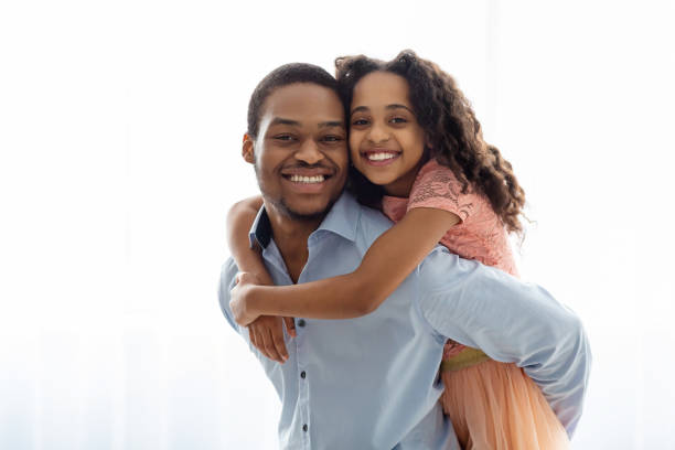 istock Cute black father and daughter bonding over white 1322897086