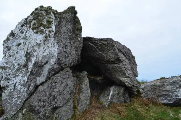 Large rocks with moss growing on the on a hill top