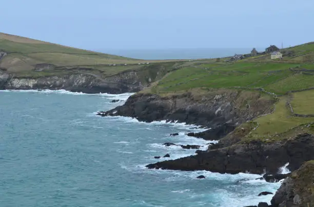 Beautiful rock coast with lush green hill tops in ireland