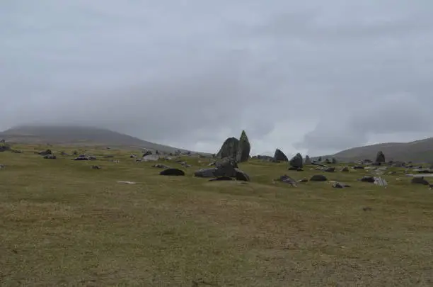 Giant boulders all of a grass field in Ireland