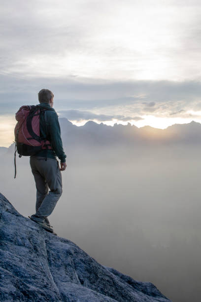 istock Mountaineer prepares rope for rappel (abseil) 1322897702