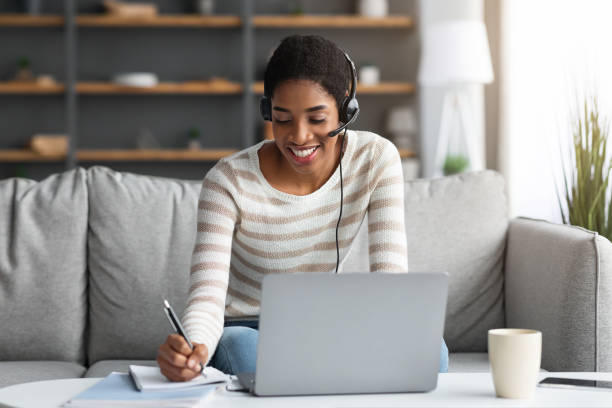 istock Online Education. Millennial Black Lady In Headset Study With Laptop At Home 1322898710