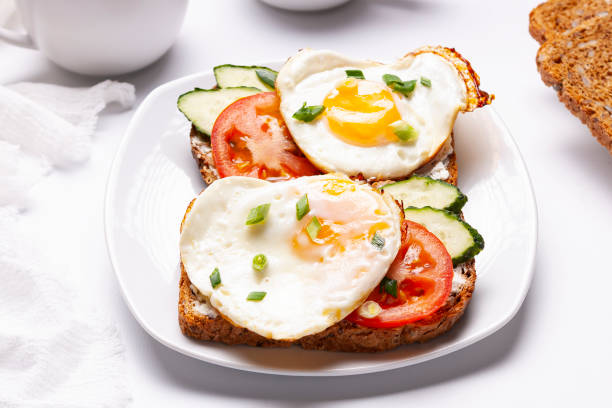 istock Sandwiches with egg, tomatoes, cucumber on toasted bread. Close up. 1322900653