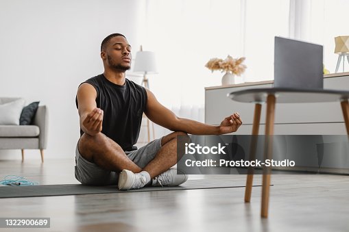 istock Peaceful African American Guy Meditating At Computer At Home 1322900689