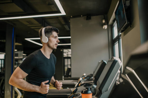 istock male athlete jogging on treadmill in a gym 1322900708