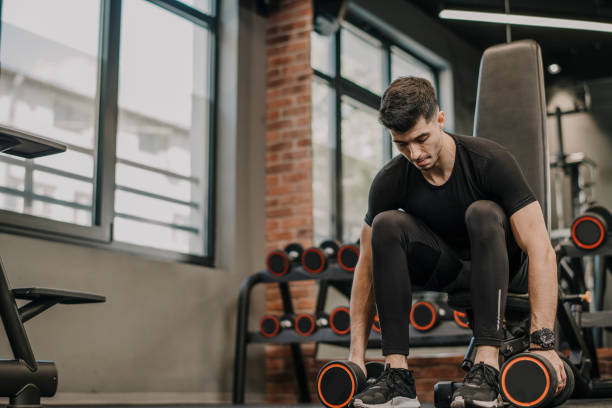 istock Man doing weight training at the gym 1322901099