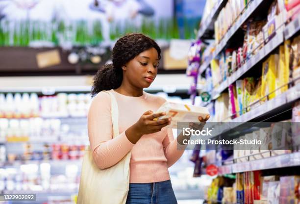 Attractive Black Woman With Tote Bag Holding Food Product Buying Groceries At Supermarket Stock Photo - Download Image Now