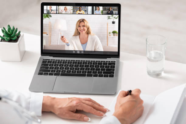 istock Young business lady having online group conference with her work colleagues on laptop from home office 1322903796