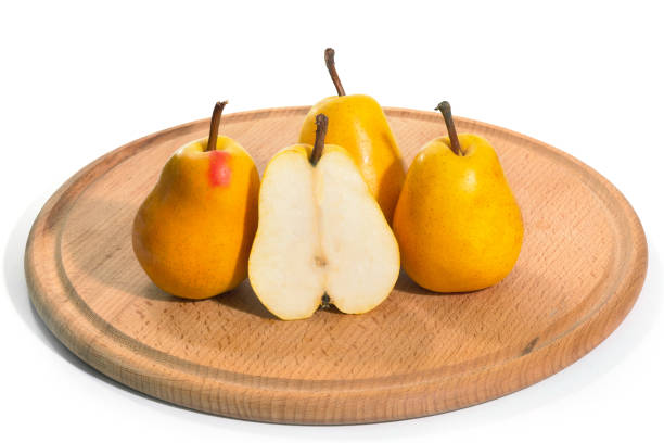 istock Yellow pears on a white background, three whole one sliced 1322906308
